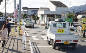 マグネットを貼り、車列パレードに出発する軽トラック=小阿坂町で